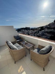 a balcony with chairs and a table and a view at Villa LaMia in Ulcinj