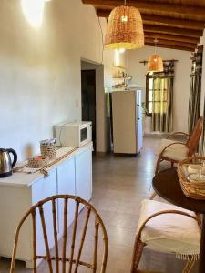 a kitchen with a table and chairs and a microwave at Departamento Santa Rita in Esquina