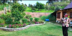 a woman standing in a yard with a garden at Cozy Hill Retreat in Gia Nghĩa +4 photos