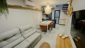a living room with a couch and a table at Casa Mar Atins in Atins