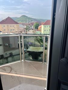 a balcony with a view of a city with buildings at Konar-Apts, Cozy Room with private kitchen, City view Balcony, 24hrs power, Security, Wifi, Gwarinpa Express by Dawaki Junction in Gwarinpa