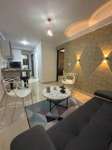 a living room with a couch and chairs and a table at Granada Luxury Loft in Cali +12 photos