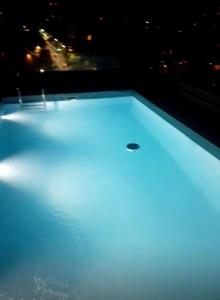 a bathtub lit up with blue lights at night at Dr Propiedades 768 in Tigre +18 photos