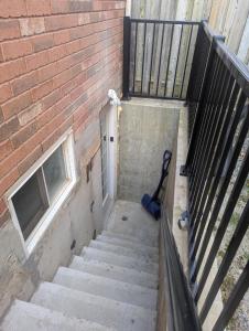 a staircase leading up to a brick building at Basement two Queen beds and one single with two full washrooms by YKF airport in Kitchener