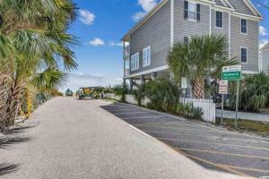 a house with palm trees on the side of a road at Seas the day llc in Myrtle Beach