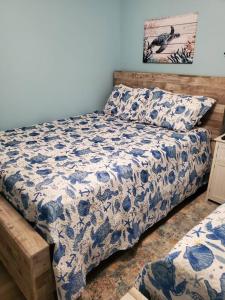 a bedroom with a bed with a blue and white comforter at Seas the day llc in Myrtle Beach +19 photos