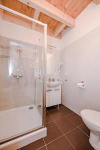 a bathroom with a shower and a toilet and a sink at Domek A 133 Caffe Latte- Kaszubska Ostoja in Barkocin