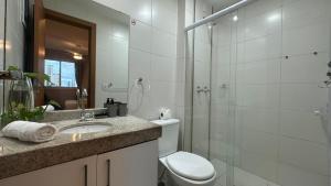 a bathroom with a toilet and a shower and a sink at Apto 2 qtos na quadra da praia Itaparica in Itaparica +22 photos