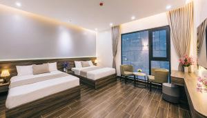 een hotelkamer met twee bedden en een raam bij Lucy Villa Sầm Sơn in Sầm Sơn +29 foto's