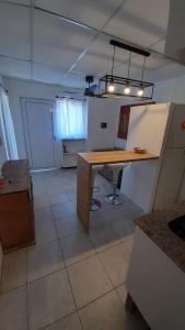 a kitchen with a wooden table in a room at El rinconcito de Lamadrid in Concordia +2 photos