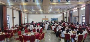 a group of people sitting at tables in a banquet hall at Kolia Resort in Cao Bằng