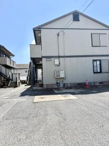 a large white building on the side of a street at inn 2nd 102 in Kurashiki