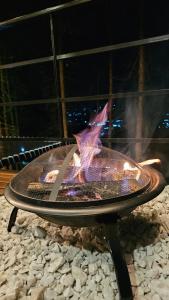 a fire pit sitting on top of a pile of rocks at Cabaña en Tabio in Tabio