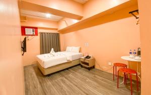 Ένα ή περισσότερα κρεβάτια σε δωμάτιο στο Kaizen Suites