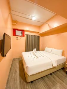 Ένα ή περισσότερα κρεβάτια σε δωμάτιο στο Kaizen Suites