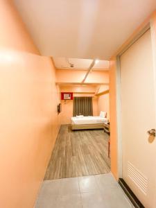 Ένα ή περισσότερα κρεβάτια σε δωμάτιο στο Kaizen Suites