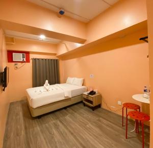 Ένα ή περισσότερα κρεβάτια σε δωμάτιο στο Kaizen Suites