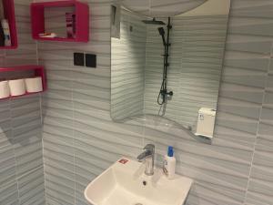 a bathroom with a sink and a mirror at منازل سارا 2 Sara Houses in Tabuk +66 photos