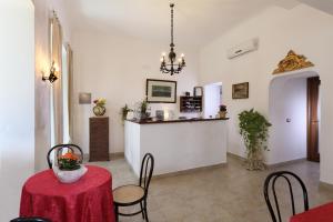 a dining room with a red table and chairs at Villa Astoria in Taormina