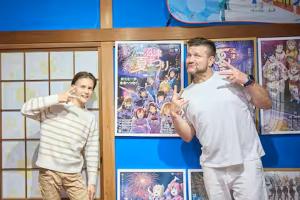 two men standing in front of a wall with pictures at Numazu Sparkle in Numazu +88 photos