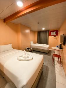 Ένα ή περισσότερα κρεβάτια σε δωμάτιο στο Kaizen Suites