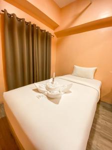 Ένα ή περισσότερα κρεβάτια σε δωμάτιο στο Kaizen Suites