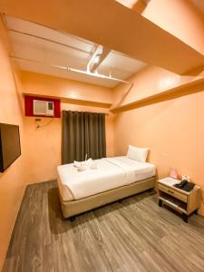 Ένα ή περισσότερα κρεβάτια σε δωμάτιο στο Kaizen Suites