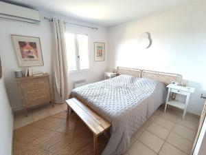 a bedroom with a bed and a table and a window at Maison 6 pers. avec jardin, terrasse, 2 piscines et parking - Alpilles/Luberon - FR-1-658-23 in Mallemort +10 photos