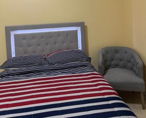 a bed and a chair in a bedroom at Room, Private Restroom and Entrance in Edinburg