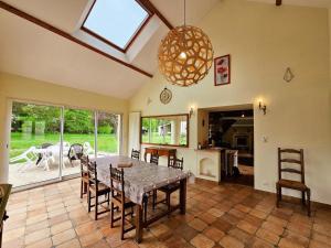 a dining room with a table and some chairs at Gîte Tourangelle avec Piscine Intérieure, Wifi, Jardin - FR-1-381-619 in Assay