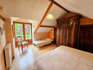 a bedroom with a bed and a chair in a room at Gîte Tourangelle avec Piscine Intérieure, Wifi, Jardin - FR-1-381-619 in Assay +28 photos