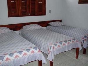 a room with three beds in a room at Residencial Recanto do Paraiso in Jericoacoara
