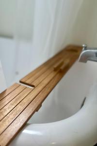 a close up of a toilet with a wooden counter top at Hilo Town Inn in Hilo +32 photos