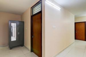 an empty hallway with two doors and a window at FabHotel Raas Inn in Lucknow