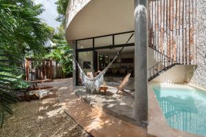 a house with a hammock and a swimming pool at 2 Tropical Bohemian Villas-2 Priv Pool-BBQ 3A-3B in Tulum