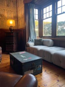a living room with an old trunk on the floor at McIntyre homestead in Penshurst