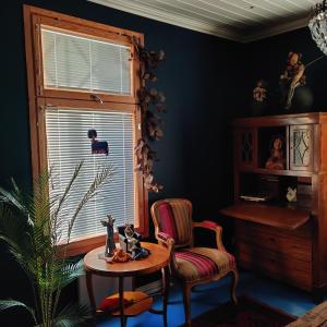 a room with a chair and a table and a window at Luukkaan Helmi in Lappeenranta