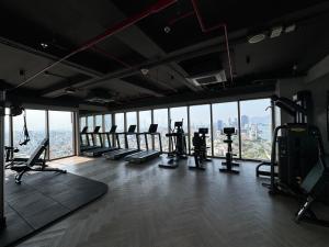 a gym with treadmills and machines in a building at The Filmore Đà Nẵng in Da Nang