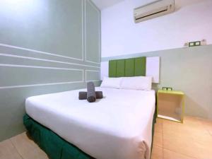 Postel nebo postele na pokoji v ubytování Seeds Hotel Bukit Bintang