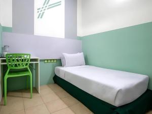 Postel nebo postele na pokoji v ubytování Seeds Hotel Bukit Bintang