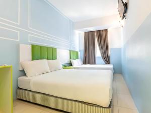 Postel nebo postele na pokoji v ubytování Seeds Hotel Bukit Bintang