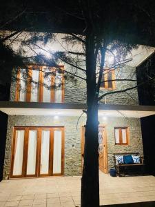a building with a garage with a tree in front of it at Cabaña rodeada de naturaleza in Pátzcuaro +1 photo