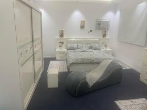 a white bedroom with a bed and a window at منازل سارا 3 Sara Houses in Tabuk