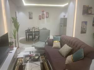 a living room with a couch and a table at منازل سارا 3 Sara Houses in Tabuk