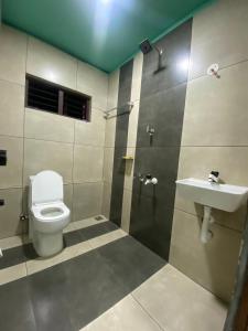 a bathroom with a toilet and a sink at CanWas Rajagiri in Ernakulam