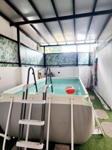 a hot tub with two chairs and a pool at Homestay 5min walk to Jonker Street Melaka in Melaka