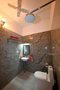 a bathroom with a toilet and a sink at Ardas Villa Bikaner - Heritage Luxury Boutique Stay, With Free Pick Up and Drop in Bikaner +51 photos