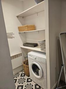 a laundry room with a washer and dryer at maison de village meublée avec terrasse in Donzère