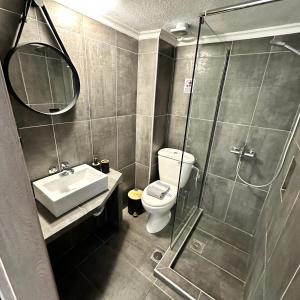 a bathroom with a shower and a toilet and a sink at R&T Apartments in Kallithea Halkidikis