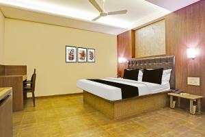 a hotel room with a bed and a desk at Collection O Nagpur Railway Station Formerly Jagannath Deluxe in Nagpur